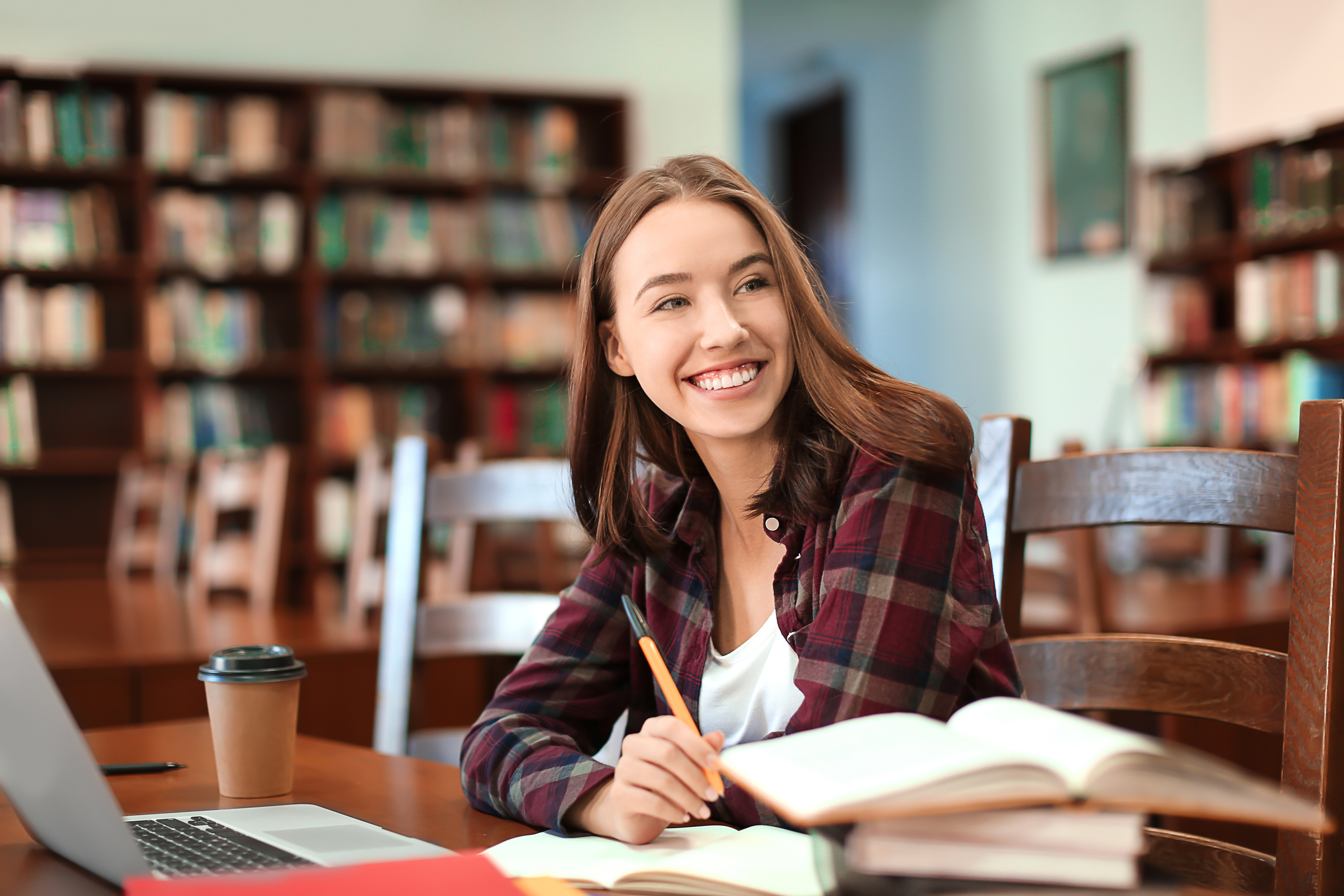 A picuture of a young woman depicted as a student in a library